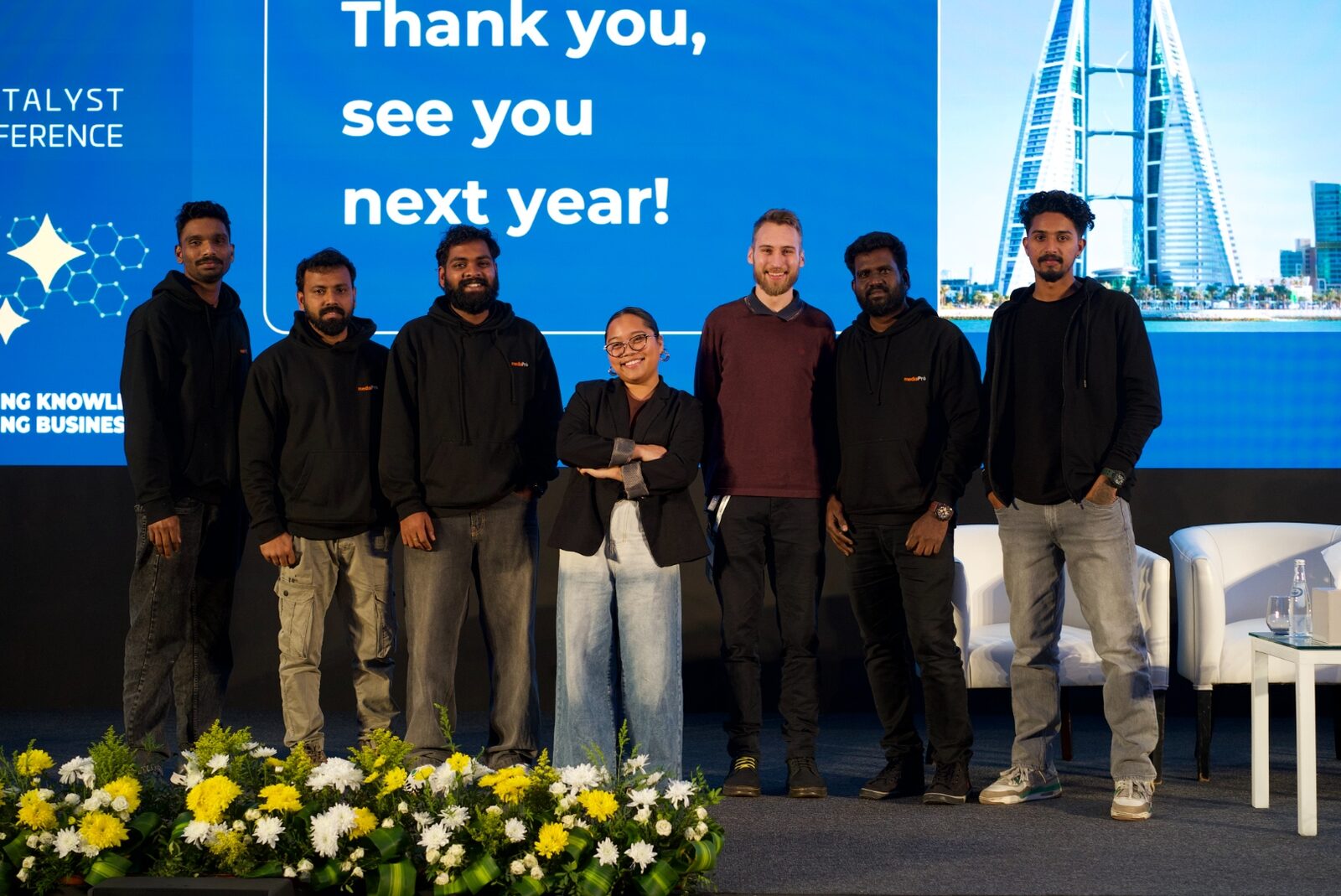 On-site crew at a conference closing — wrap-up moment with the team.